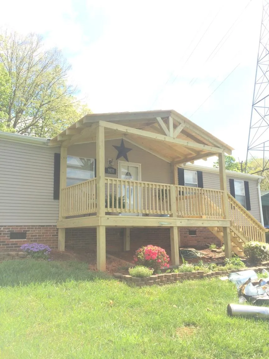 New gabled porch roof and deck railing added to a ranch home in Nelliston